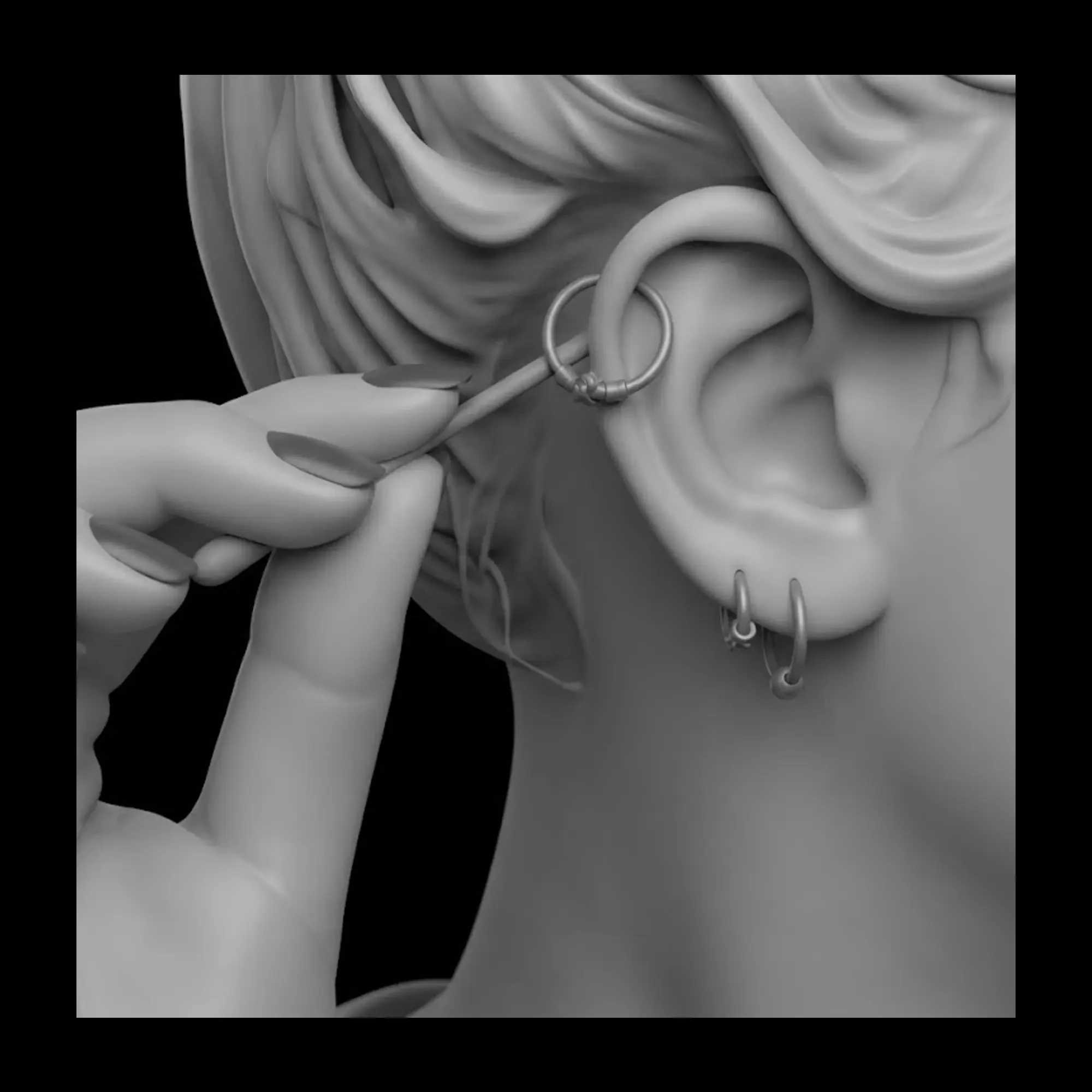Fingers twisting a hoop in an ear piercing